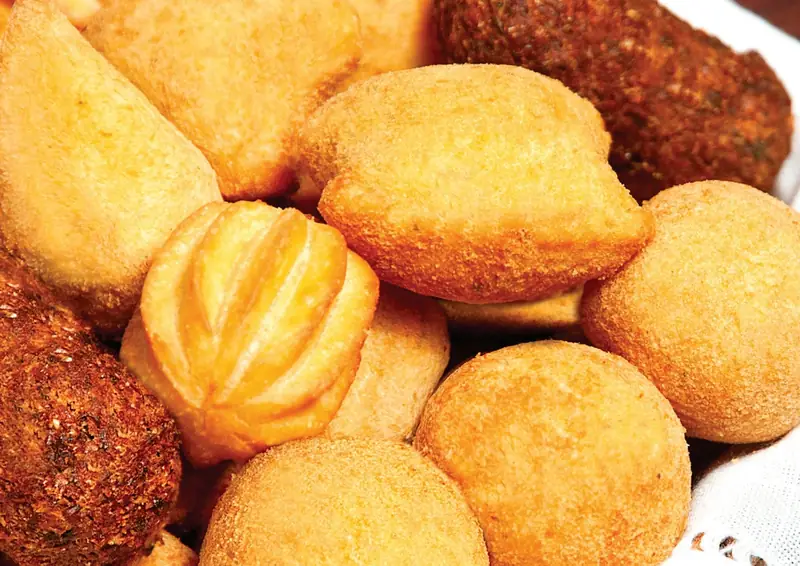 Cesta de salgadinhos de festa fritos: coxinhas, bolinhos e kibes